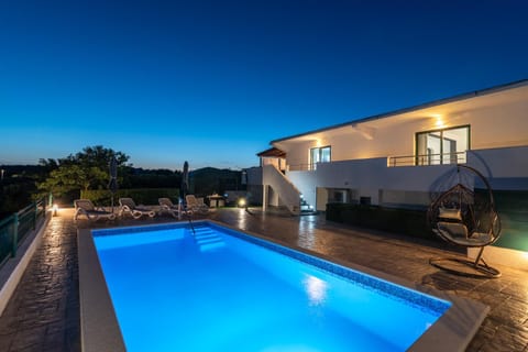 Property building, Patio, Night, Natural landscape, Pool view, Swimming pool, sunbed