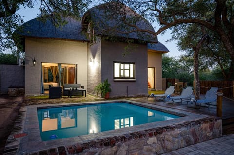 Property building, Patio, Pool view, Swimming pool, sunbed
