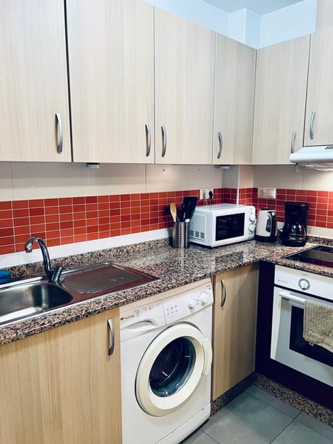 Kitchen or kitchenette, oven, stove, washing machine