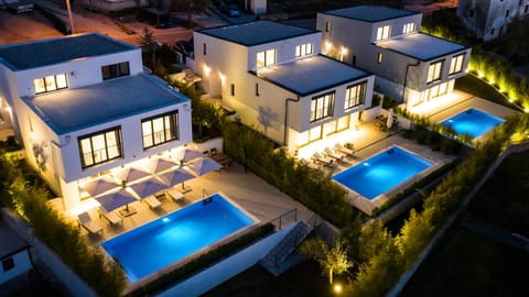 Property building, Patio, Night, Swimming pool, sunbed
