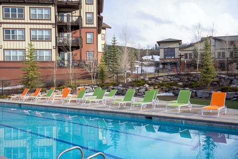 - Dive into relaxation at the sparkling outdoor pool with scenic views   - Lounge on colorful chairs after a refreshing swim in the mountain air   - Resort-style poolside seating makes every sunny day more enjoyable