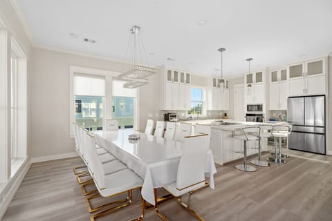 Dining room with 12 seats and 4 barstools at kitchen island