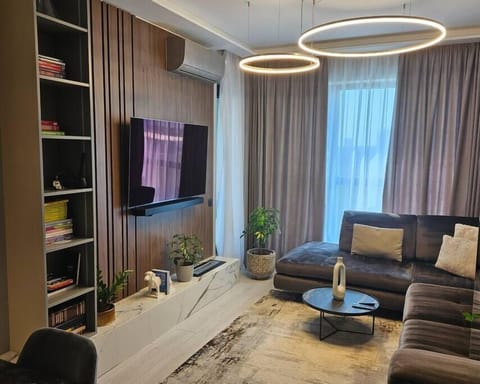 Spacious living room with dining table, access to balcony with gorgeous city view, an indoor fireplace, AC and a 140cm TV SMART Samsung OLED
