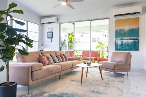 Bright living area with two AC units and an access to the private terrace