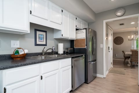 The kitchen has custom cabinets and stainless steel appliances.