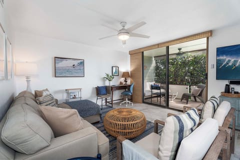 Spacious living area with a sofa sleeper, large flat-screen TV, and Blu-Ray player.