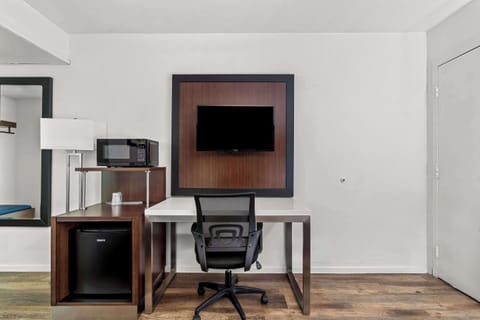 Premium bedding, desk, laptop workspace, blackout drapes