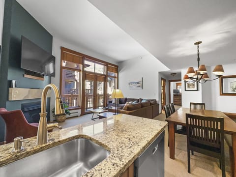 Modern kitchen looking into the rest of the living area.