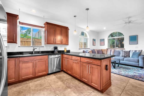 Spacious and fully equipped kitchen adorned with beautiful granite countertops, offering plenty of room for meal prepping.