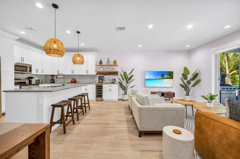 The open plan layout connects the kitchen seamlessly to the dining and living areas, allowing for easy flow and interaction with guests. It's perfect for hosting dinner parties, family gatherings, or simply enjoying the company of loved ones while prepari