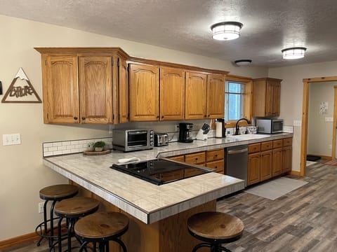 The kitchen with breakfast bar is fully equipped with everything needed.