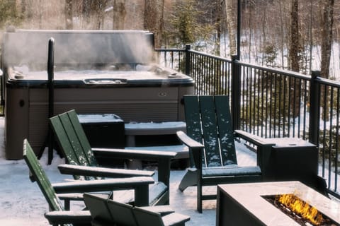 Back deck with hot tub and lounge area overlooking the Vermont woods.-