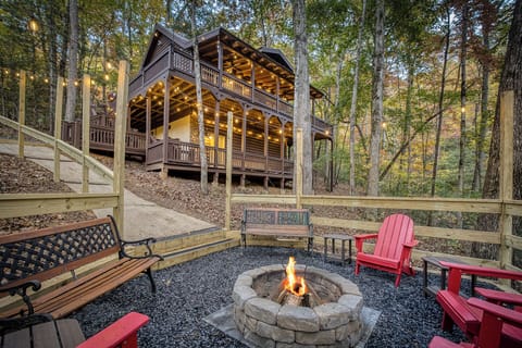 Step out of the car and let the mountain quiet hit you — string lights flicker on along the deck while the fire pit waits just a few steps below, ready for the first night of the trip.