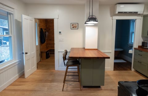 Large eat in kitchen with island, fully stocked with new appliances.