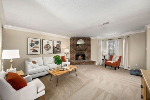 Bright living room with cozy seating, fireplace, and Smart TV — perfect for relaxing after exploring Montrose
