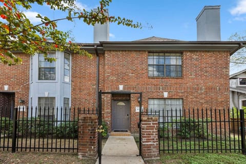 Front exterior of Montrose Manor with private entrance to Unit 607 inside a gated fourplex
