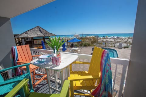 Wake up to stunning Gulf views from your private balcony, where colorful beach chairs and tropical touches create the perfect spot for morning coffee.