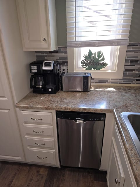 Fully stocked kitchen featuring Keurig/coffee pot, dishwasher and toaster