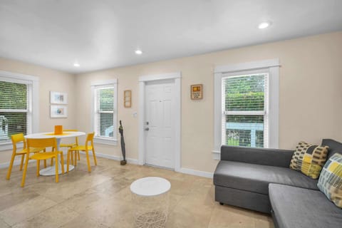 Enjoy the tranquil living and dining zone, complete with a cushy sofa that effortlessly converts into a bed for added relaxation