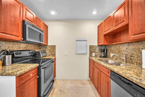 Spotless, generously-sized, and equipped kitchen with ample storage, ensuring a seamless cooking experience.