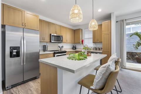 Fully equipped kitchen with additional barstool seating.