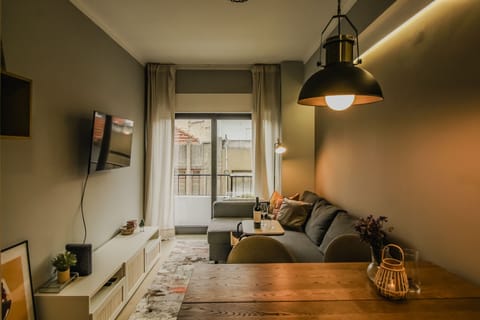 Living room with sofa bed, smart tv and dining table