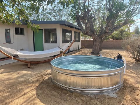 Escape the desert heat in the shaded cowboy pool and relaxing hammock to experience the beauty of a Joshua Tree sunset.