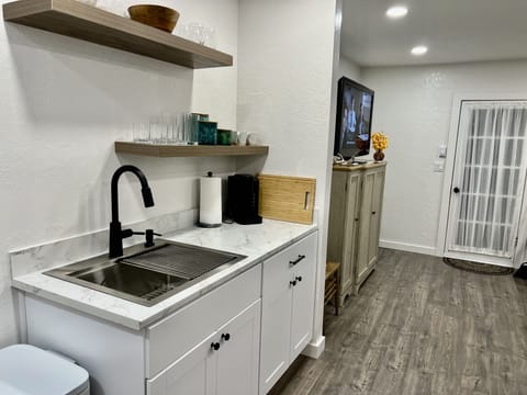 Kitchen and living room pictured.  Back door leading to fenced sunny yard.