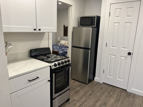 Kitchen with large apartment refrigerator.