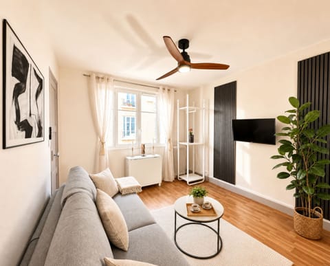 Comfortable living space with a double sofa bed and ceiling fan