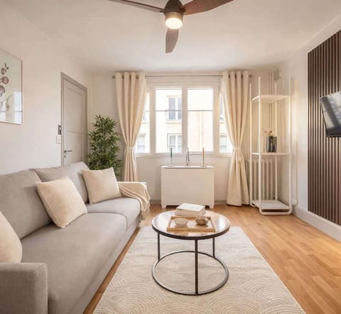 Comfortable living space with a double sofa bed and ceiling fan