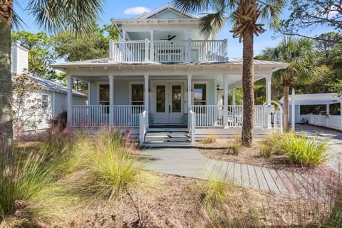 - Classic coastal home framed by palms & grasses welcomes you to Seaside charm - Double porches offer tranquil spots to sip coffee, feel the breeze, & enjoy the scenery - Storybook entrance leads to sun filled interiors made for relaxing beach days