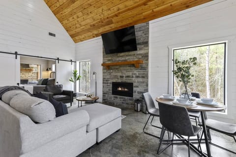 Savor your meals by the cozy fireplace while gazing out at the majestic pine trees surrounding you.
