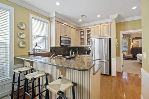Fully equipped kitchen with counter seating on first floor.