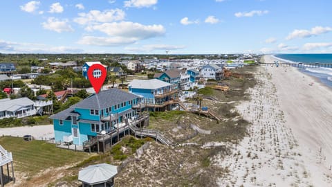 Aerial view of beachfront vacation rental community with sandy shores and ocean access.