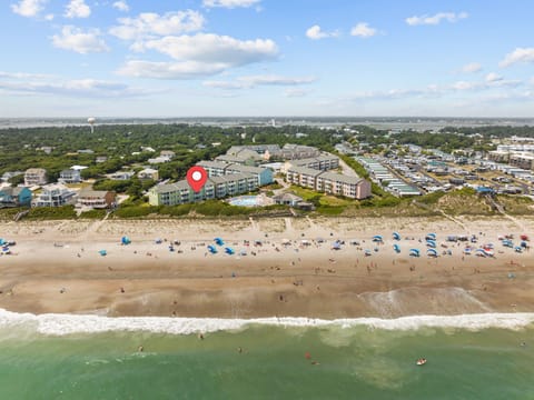 Aerial view of beachfront property with direct beach access and convenient location near coastal amenities.