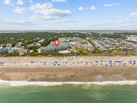 Beachfront property location with direct access to sandy shores and ocean activities in a vibrant coastal community.