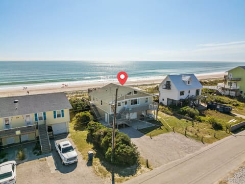 Beachfront coastal community with vacation homes just steps from pristine sandy shores and rolling ocean waves.