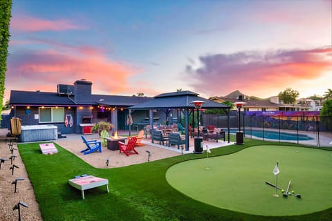 Backyard fun for all ages - putting green, cornhole, hot tub, and heated pool.