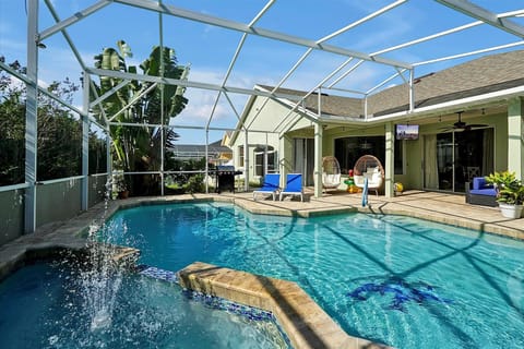 Amazing outdoor living with a heated saltwater pool and spa, plenty of seating an an outdoor TV