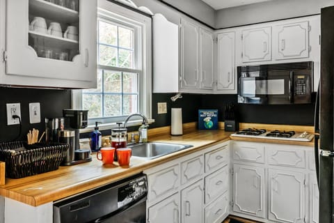 Kitchen with ample cupboards coffee station and glass and dish wares