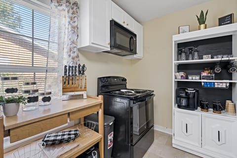 Fully equipped kitchen with a stocked beverage center. 