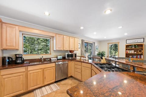 Full kitchen stocked with cookware and tableware