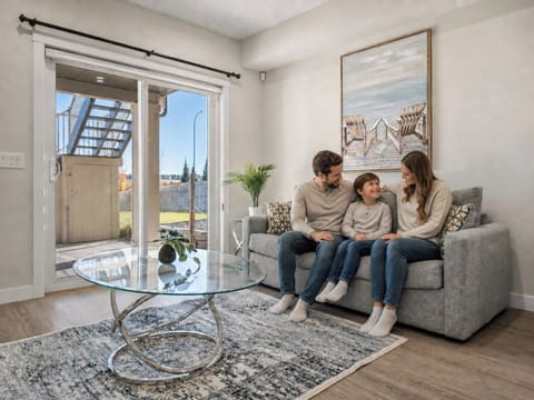 Spacious living room with glass doors opening to outdoor patio area