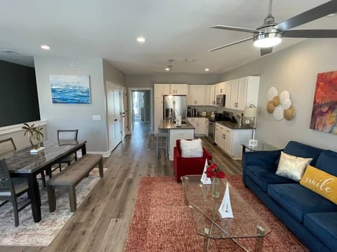 Living Room: Bright open layout with inviting seating, modern kitchen, and vibrant decor for fun gatherings!