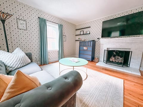 Living room equipped with board games, Playstation, and smart TV