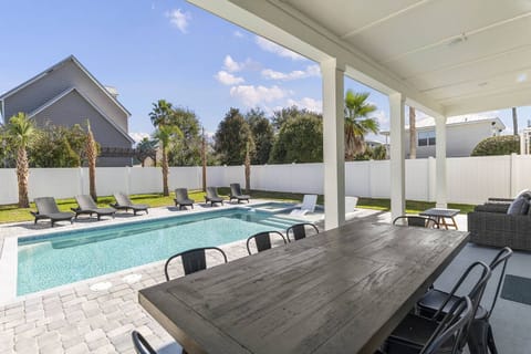 Covered outdoor dining area overlooking the pool, perfect for relaxed meals.