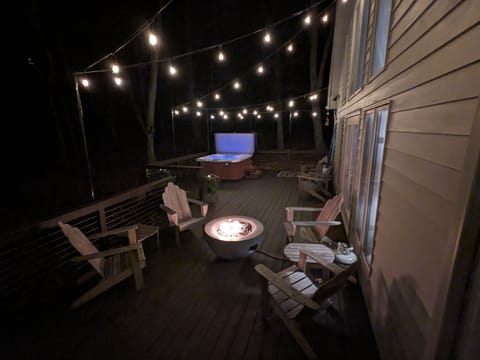 Large deck with salt water hot tub, firepit, dining area, and Weber gas grill.