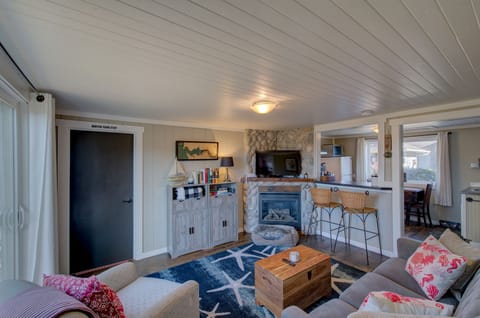Living room with electric fireplace and dog bed