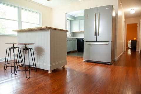 Handmade island with storage, water dispenser, fridge/freezer and kitchen. 